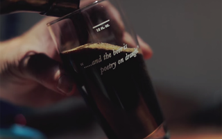 Dark beer being poured into glass on draught